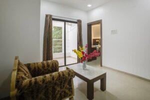 staybird 1bhk room with sofa and balcony