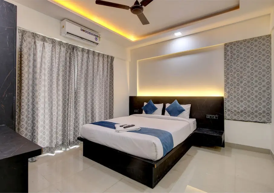 Staybird hotel room with bed , A/C and television.